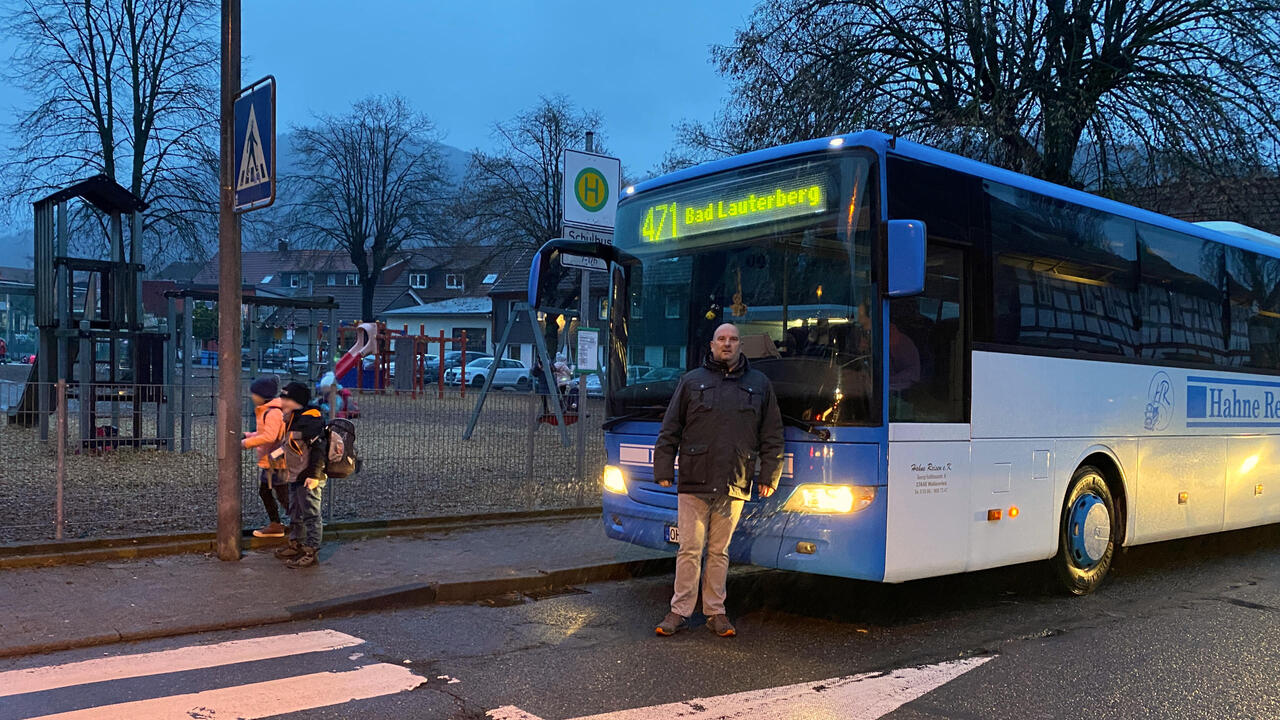 Manuel Spittmann vor einem Bus vor der Grundschule Bad Lauterberg